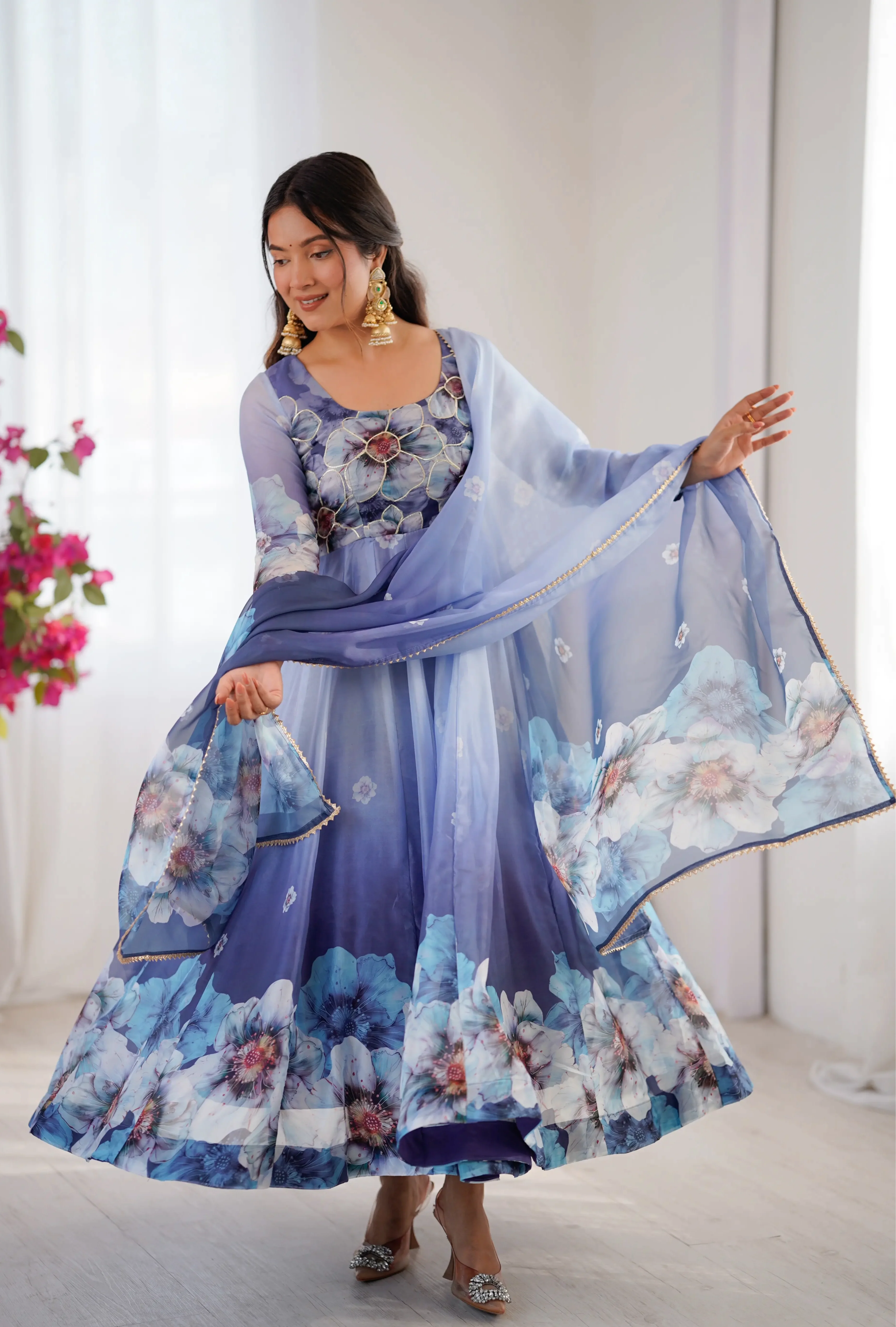 A floral printed gown is a versatile, full-length garment that combines a timeless silhouette with vibrant, feminine patterns